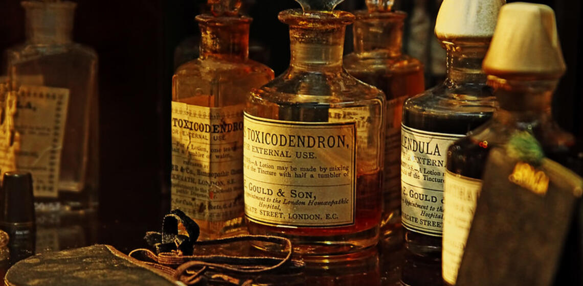 Image of 5 antique, amber-colored medicine bottles.