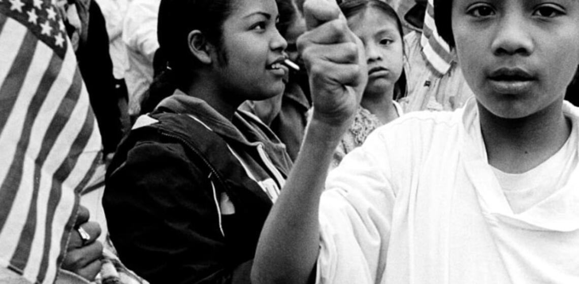 Black and white image of children holding US flag